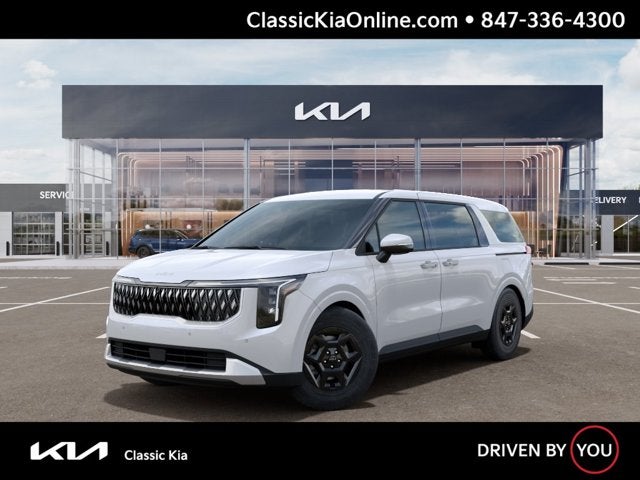 2026 Kia Carnival LXS in Snow White Pearl — front three-quarter view